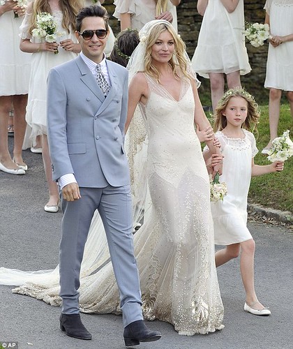 The couple strides into the village after marrying in a Church of England ceremony