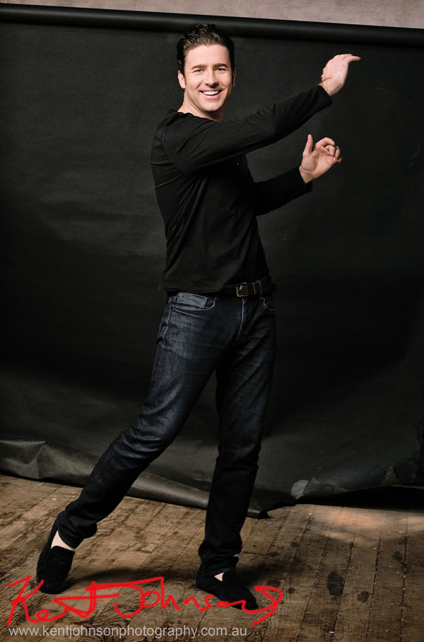 Male Modelling Portfolio, Colour against black back drop, action shot, jeans and Tee shirt
