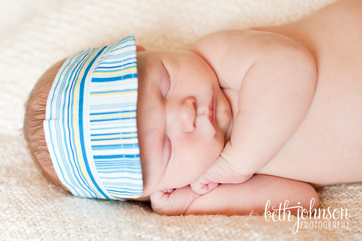 newborn baby boy in visor hat photography
