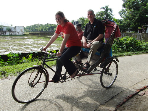 Iona carrying  Justin by a rikshaw