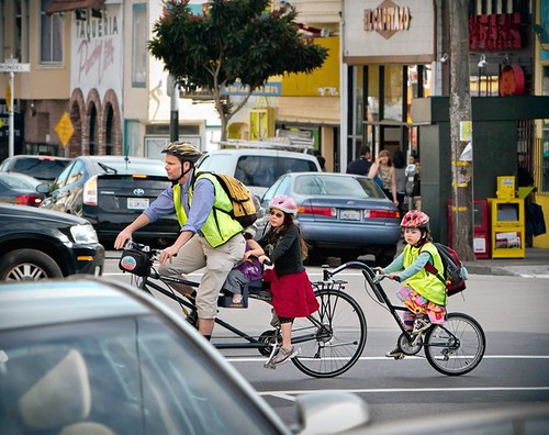 A family outing with four on a bike at 16th and Valencia St, along a new bike corridor created by the city of San Francisco