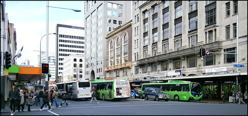 Pedestrian and buses on Custom St