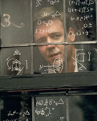 Russell Crowe looks out a window covered in scribbled math.