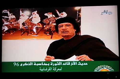 Poster Libyan revolutionary leader Muammar Gaddafi speaking on television in the North African oil-rich state. Libya has fought off an imperialist onslaught for the last eight months. by Pan-African News Wire File Photos