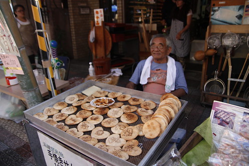 Old man selling cookies/ pancakes?