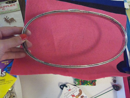 This is an old embroidery hoop I got, too. It is all metal and has cork on the inner hoop to hold it tight. I never saw one like this.