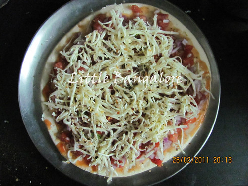 Grated cheese on pizza base