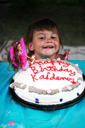 Kaidence poses by her melting birthday cake