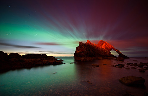 Northern Lights behind Bow Fiddle Rock, Moray, Scotland by Kenny Muir