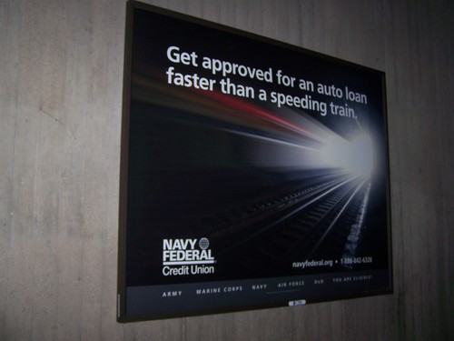 Navy Federal Credit Union ad promoting car loans in a transit station (Union Station)