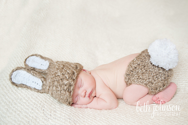 newborn baby in baby bunny hat and diaper cover