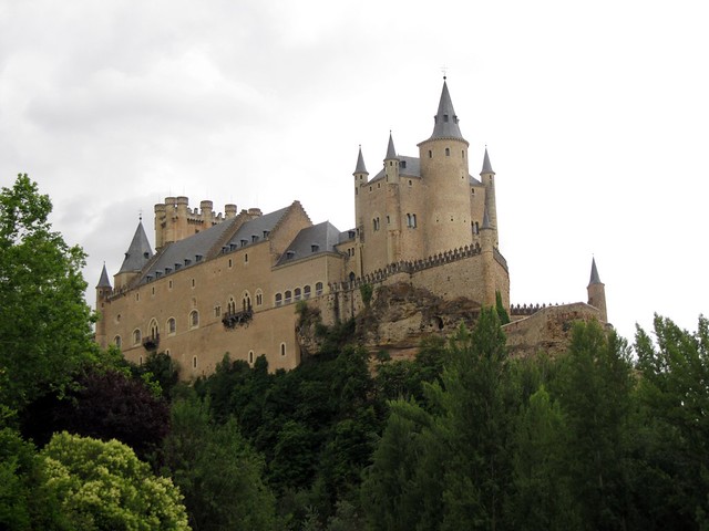 View of the Alcázar of Segovia from a grass patch below