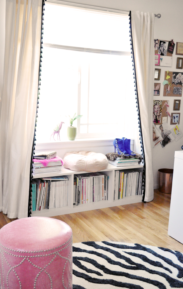 office window with storage bench + pink studded ottoman