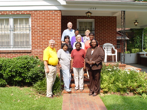 (Front row, from right to left) State Director George, Ms. Spearman, Ms. Monger, and Grenada Mayor Collins stand in front of Ms. Monger’s new home in Grenada.