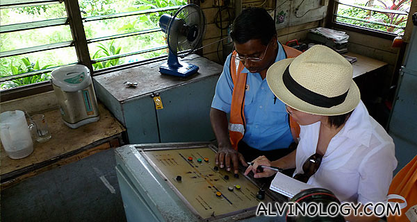 Mr Manikavasam teaching Rachel how to operate the control panel