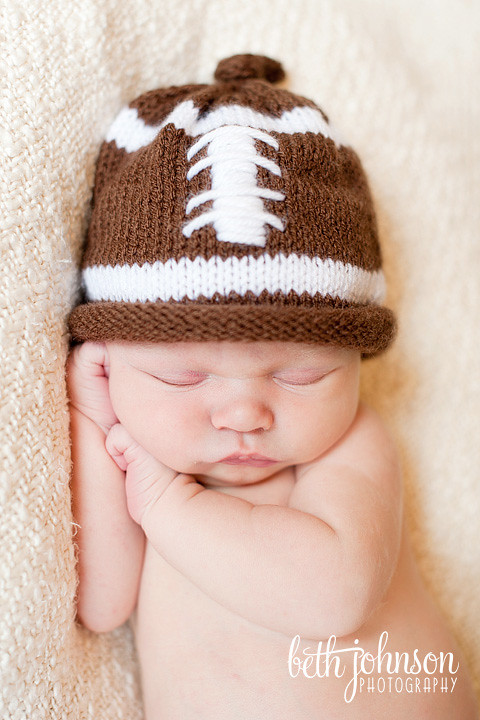 newborn baby boy in football hat