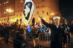 Six-year Navy veteran Joshua Sheperd holds a veterans for peace flag during a demonstration by Occupy Oakland at the intersection of 14th and Broadway Streets in Oakland, Calif. Tuesday, Oct. 25, 2011. Photo by Erik Verduzco.