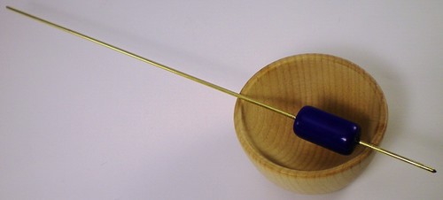 blue bead on a brass shaft