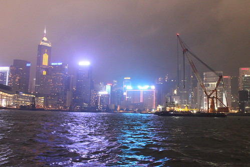Hong Kong skyline night view from a ferry on Victoria Harbor. by emaggie