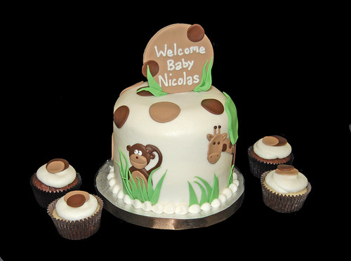 cream and brown jungle themed baby shower cupcake tower with monkey and giraffe