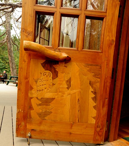 Owl forest, fitted polished wood door, with natural handle, glass panels, lodge deck, Breitenbush Hot Springs, Breitenbush, Marion County, Oregon, USA by Wonderlane