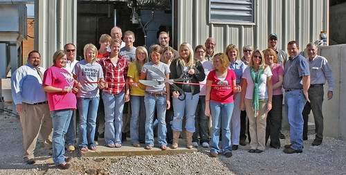Students, speakers, and honored guests cut the ribbon at Southern Reynolds County R-II School Districts wood chip fired heating plant. USFS photo.