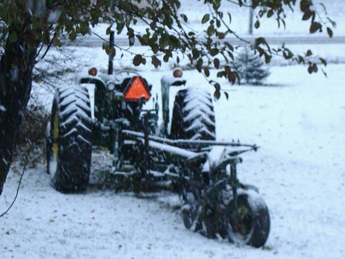 Snowy tractor and plow