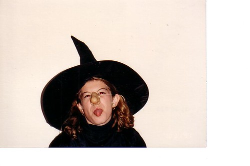 A picture of the author at 10 years old sticking her tongue out in a more conservative withc costume