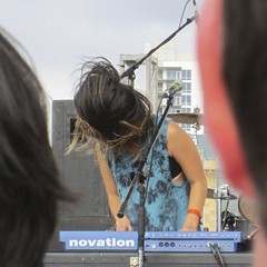 picture two of three of Yuki Chikudate's at the keyboards, her hair blowing up