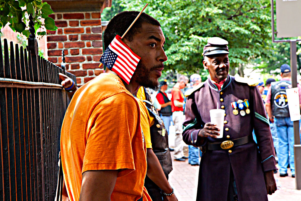 Man-with-upside-down-flag-over-ear--Olde-City