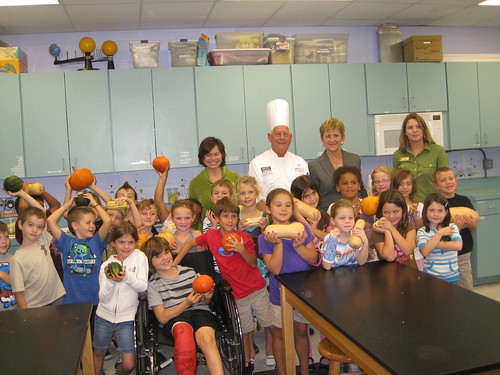 Deputy Under Secretary Janey Thornton (center right) and American Culinary Federation Chef David S. Bearl (center left) pose with RB Hunt Elementary first graders from Christine Skipp’s and Lori Hall’s class as they show off pumpkins. Thornton and Bearl visited the school located in St. Augustine, Fla., on Oct 18, to celebrate Farm to School Month and First Lady Michelle Obama’s Let’s Move! Chefs Move to Schools initiative. The pumpkins were harvested from the University of Florida’s Institute of Food and Agricultural farm, Hastings, Fla., and were also used in the school’s lunch for the day. (Photo by Lanna Kirk)