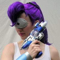 A headshot of a woman dressed like Leela, complete with purple ponytail and raygun