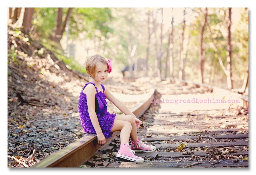 Sarah knees together on the railroad tracks BLOG