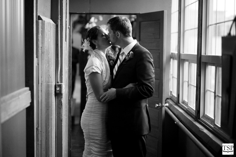 Bride and Groom Kiss in Hallway