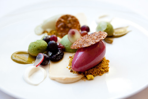 Pistachio cakes with grapes, almonds, and candied pistachios, pistachio ice cream and grape sorbet