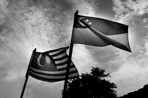 Singapore and Malaysia flags fly side by side over the Bukit Timah KTM railway station
