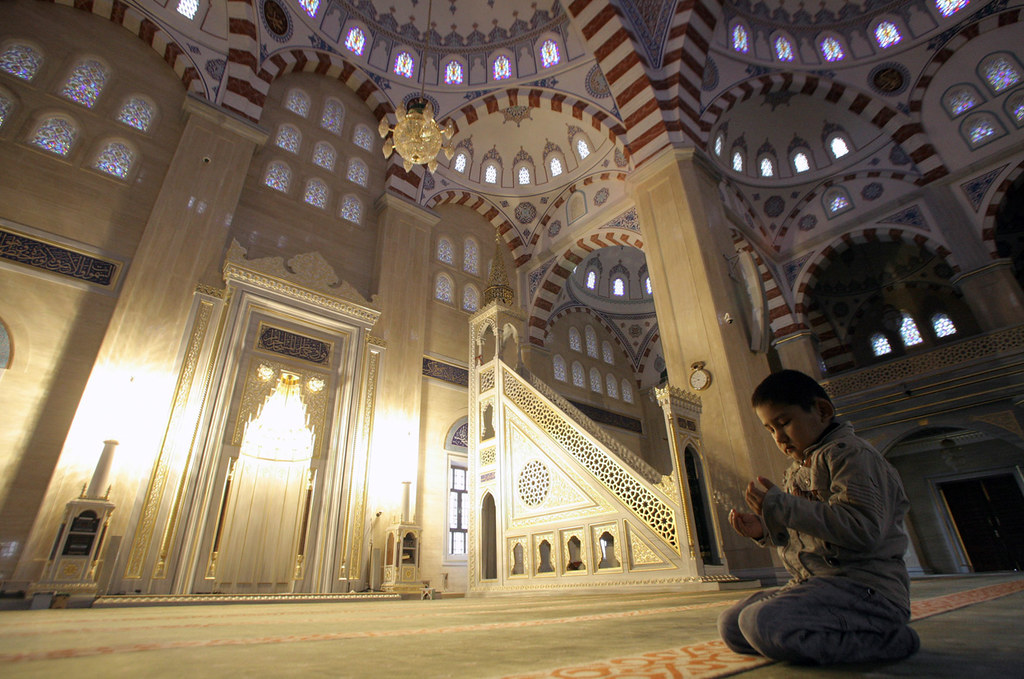 A Chechen boy prays in the main mosque in Grozny, Russia, 
