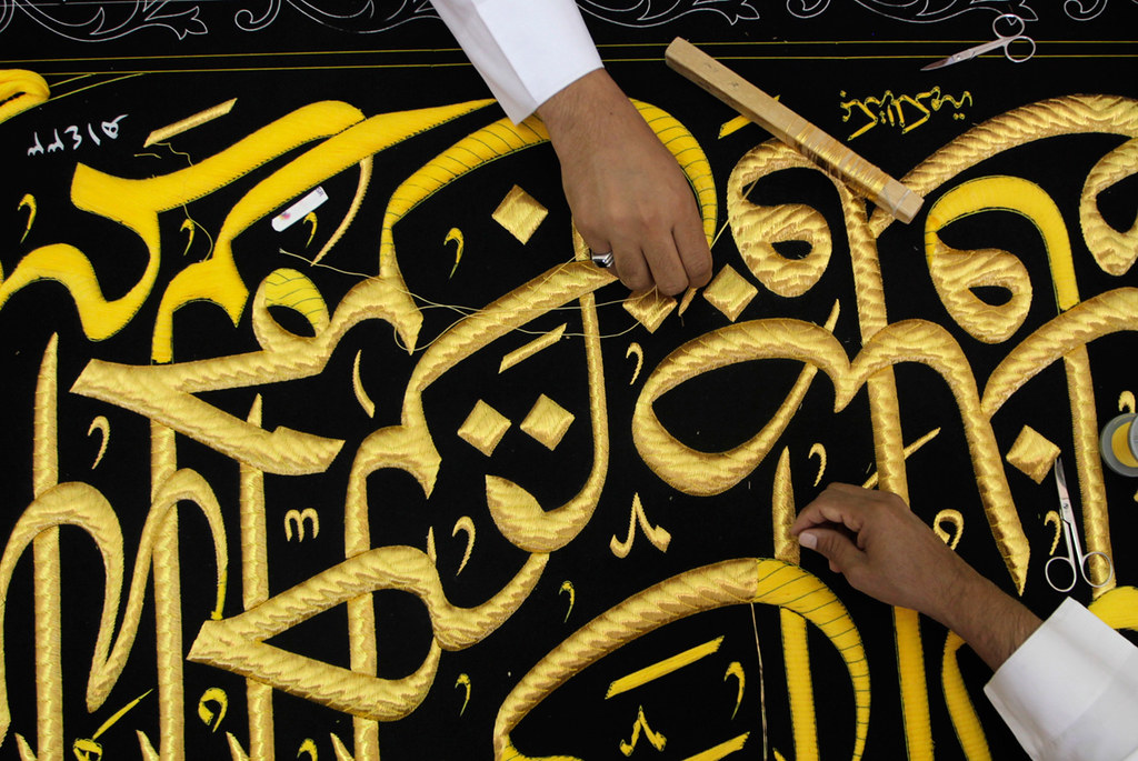 Workers embroider the Kiswa, a silk cloth covering the Holy Kaaba, in the holy city of Mecca