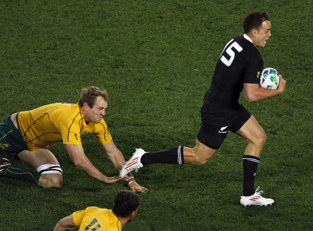 All Black Israel Dagg runs past Australia's Rocky Elsom, left, during their Rugby World Cup semifinal at Eden Park