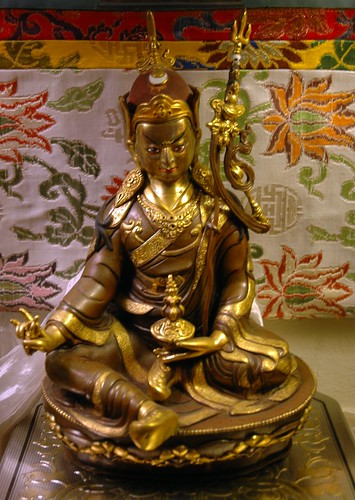 Statue of Padmasambhava, 8th century saint who brought Buddhism to Tibet, floral Tibetan style silks, khata (kata), ornate box, Seattle, Washington, USA by Wonderlane