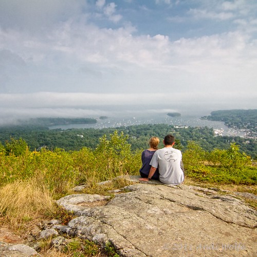 Young couple enjoying the view of Camden Harbor from Mount Battie by andiwolfe
