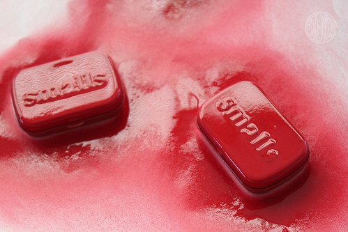 spray painting altoid cans with red spray paint 