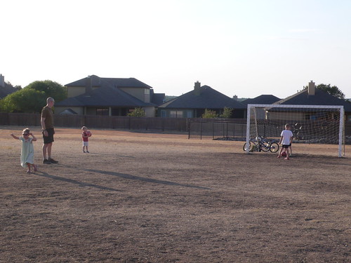 Playing soccer at the field behind our school