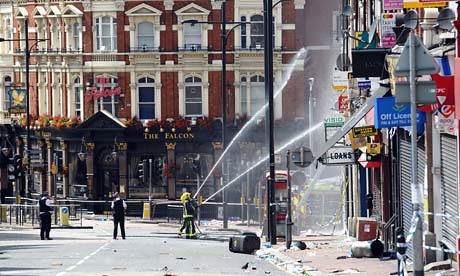 Firefighters spray water on building set ablaze during the Black youth-led rebellion in several cities across the country including London, Manchester, Britsol, Birmingham and other areas. by Pan-African News Wire File Photos
