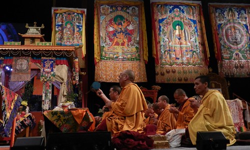 Tibetan Buddhist Khenpo leading lamas in offerings to the deities, facing the Kalachakra pavilon, Thankgas of Padmasambhava, Kalachakra, Buddha, Kalachakra Mandala, Verizon Center, Washington D.C., USA by Wonderlane
