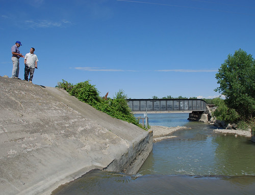 Dale Bilyeu, manager for the Huntley Irrigation Project, and Nick Vira, NRCS district conservationist in Billings, look out over the repaired Pryor Creek channel. 