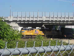 A container freight emerges from the shade of the new 99e viaduct