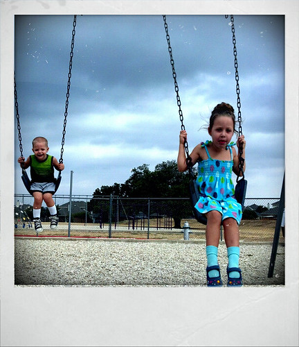 Daisy and Billy swinging on the school playground