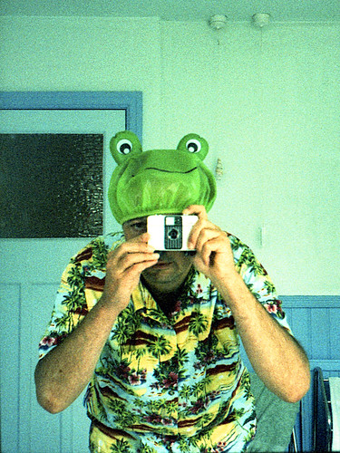 reflected self-portrait with Ricoh Auto-Half camera and frog shower cap by pho-Tony