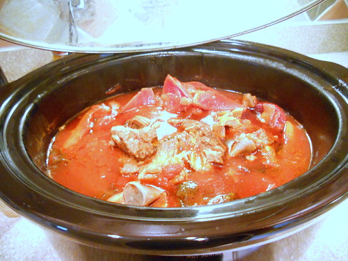 Finished stew with red broth in crock pot.